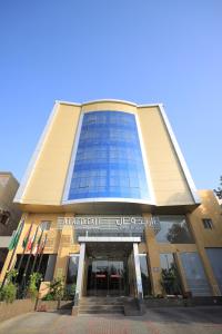 a large building with a glass facade with a entrance at الريد فال للشقق المخدومة in Jeddah