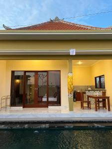 a house with a pool in front of it at Villa Lestari in Ubud