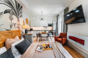 a living room with a couch and a table at RoomChic - Les Ambassadeurs in Vichy