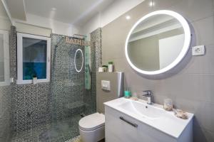 a bathroom with a sink and a toilet and a mirror at Villa Diana 2 Zaton in Zaton