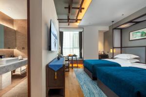 Postel nebo postele na pokoji v ubytování Glean Hotel Xinzhou