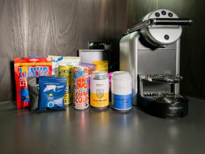 a counter top with a coffee maker and some food at Bloc Hotel Birmingham in Birmingham