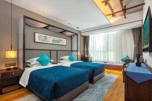 Postel nebo postele na pokoji v ubytování Glean Hotel Xinzhou