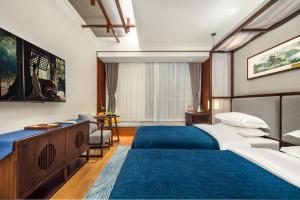 Postel nebo postele na pokoji v ubytování Glean Hotel Xinzhou