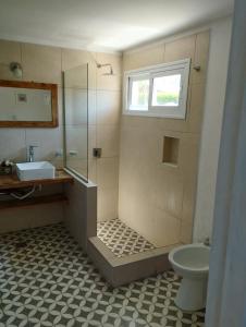 a bathroom with a shower and a sink and a toilet at Starry Lodge in Ciudad Lujan de Cuyo