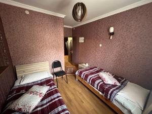 A bed or beds in a room at Guest house chavchavadze N23