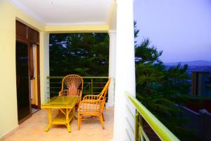 a patio with two chairs and a table on a balcony at The Country Inn Hotel in Kigali