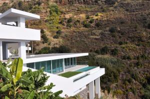 a house on the side of a mountain at Villa Gia in Calheta