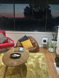 a living room with a coffee table and a couch at Yarra Valley Lifestyle Complete Home in Healesville Accommodates 6 adults Close to wineries Beautifully styled with excellent amenities Walk to town Welcome to No 4 Plenty of parking and outdoor space in Healesville