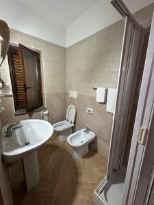 a bathroom with a sink and a toilet and a shower at Hotel Canada in Falerna Marina +24 photos