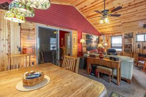 a dining room with a table and a ceiling fan at Nordico Point in Ely
