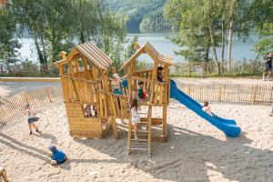 a group of children playing in a playground at Camping la Source in Thérondels