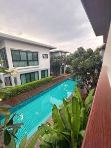 an image of a swimming pool in front of a house at Chic Villa 6 in Chiang Mai +1 photo