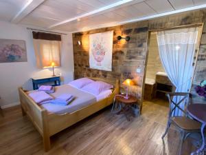 a bedroom with a bed and a table and chairs at Les Monts d'Amara, ressourcement, nature, santé in Campuac