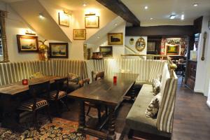 
a living room filled with furniture and a table at The Greyhound Coaching Inn in Lutterworth
