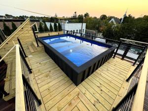 a large swimming pool on a wooden deck at Unit C, The Kroger Lofts in Charlevoix