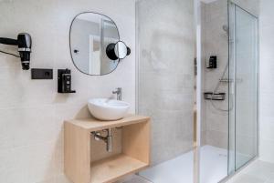 a bathroom with a sink and a shower at Limehome Santiago de Compostela in Santiago de Compostela