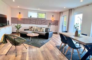 a living room with a couch and a table at Große Wohnung Wellness + Sauna + Netflix in Petershagen