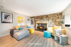 a living room with a couch and a fireplace at Beach Cottage, Pet & Family Friendly Stay in Moray in Lossiemouth