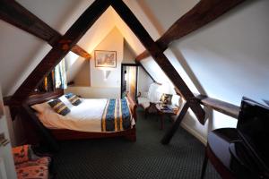 a bedroom with a bed and a desk at The Greyhound Coaching Inn in Lutterworth