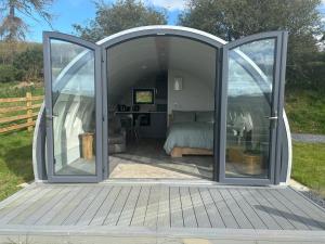 una camera da letto in una tenda a cupola con porte scorrevoli in vetro di Sky High Glamping a Shillelagh