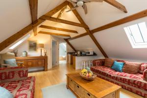 a living room with a couch and a table at The Hideaway-South Downs National Park in Graffham