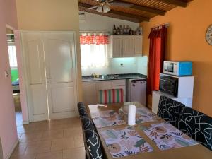 a kitchen with a dining table and a kitchen with a stove at Las Marias in San Juan