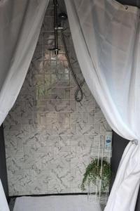 a window with a curtain and a potted plant at Glamping Cabin - Great for Hikers - Breakfast inc! in Swanage +20 photos