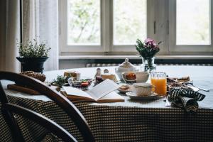 a table with an open book and a plate of food at La Corte di San Rocco in Trento +27 photos