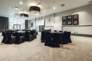 a conference room with a long table and chairs at Village Hotel Manchester Ashton in Ashton under Lyne