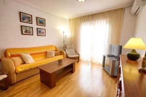a living room with a couch and a coffee table at Cuencaloft San Vera in Cuenca