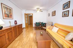 a living room with a couch and a table at Cuencaloft San Vera in Cuenca