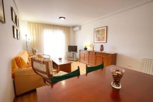 a living room with a table and a couch at Cuencaloft San Vera in Cuenca +20 photos