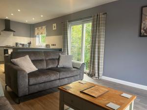 a living room with a couch and a table at Glenlochy Apartments in Fort William