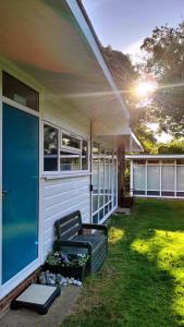 a porch with a bench on the side of a house at The Warren Chalet in Cromer