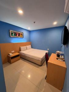 Postel nebo postele na pokoji v ubytování South of The Clouds HOTEL KL Sentral 吉隆坡彩云之南酒店-中央车站店