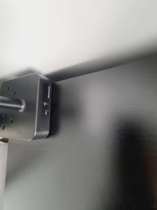 a close up of a camera hanging from a wall at QUICK STOP-GATWICK STAY, Triple room in Ifield