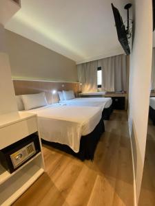 Cama ou camas em um quarto em Hotel WZ Jardins