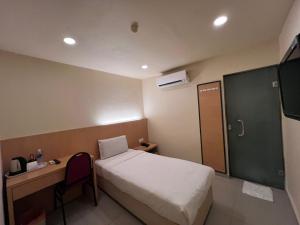 Postel nebo postele na pokoji v ubytování South of The Clouds HOTEL KL Sentral 吉隆坡彩云之南酒店-中央车站店