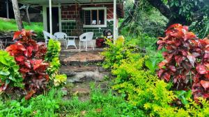 a house with two chairs and a table in the yard at Qatsyir Horizon in Varagampadi