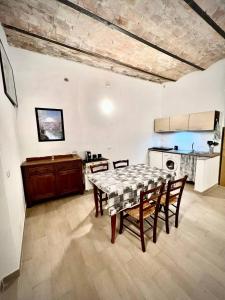 a kitchen and dining room with a table and chairs at L'Antica Grotta in Campagnano di Roma