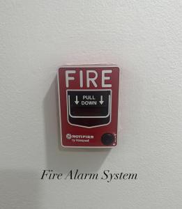 a fire alarm on a wall with the words fire alarm system at Surin Bay Inn in Surin Beach