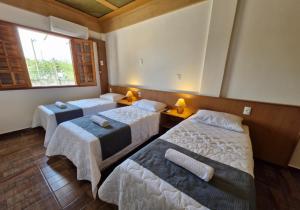 Ένα ή περισσότερα κρεβάτια σε δωμάτιο στο Pousada Villa Jardim