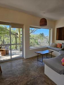 a living room with a couch and a large window at MONTE ZION in Coneta