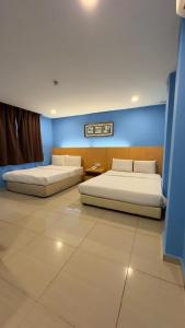 Postel nebo postele na pokoji v ubytování South of The Clouds HOTEL KL Sentral 吉隆坡彩云之南酒店-中央车站店