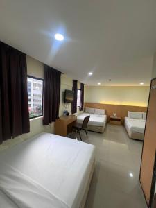 Postel nebo postele na pokoji v ubytování South of The Clouds HOTEL KL Sentral 吉隆坡彩云之南酒店-中央车站店