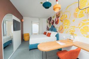 a hotel room with a bed and a desk at Albergo Dipinto BaccoFurore in Furore