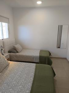 a living room with two beds and a couch at alquilaencanarias Casa La Playa La Gomera in Alojera