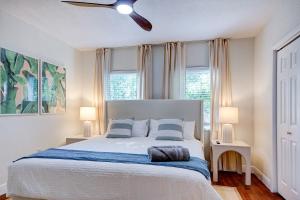 a bedroom with a bed and two windows at Luxury Home in Brickell Miami, 5 min to the Beach! in Miami