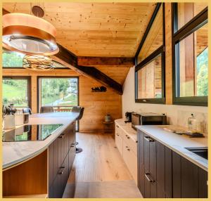 Cabaña con cocina con techos de madera y ventanas. en Le Grand Condor I Duplex I Morzine, en Morzine